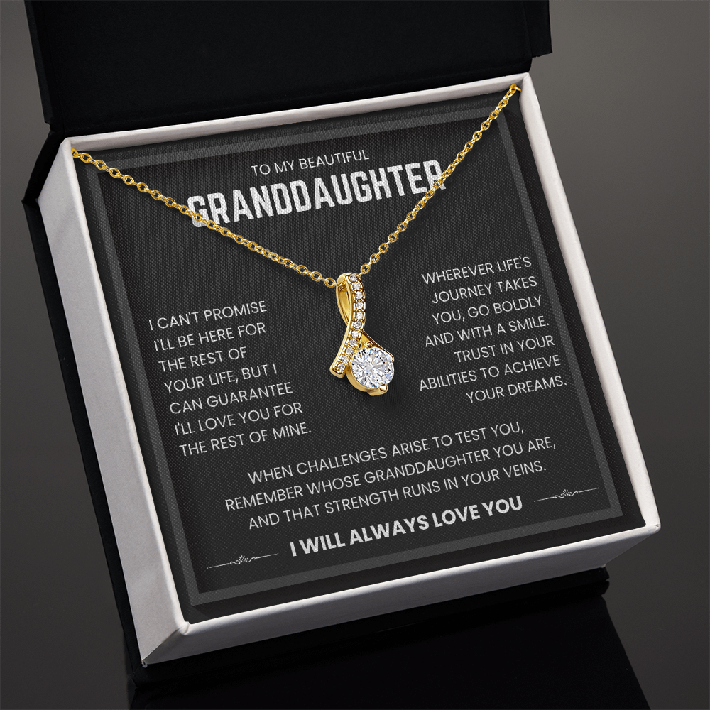 Alluring Beauty necklace in gift box with heartfelt message for granddaughter, featuring a 18k yellow gold finish and ribbon-shaped pendant.