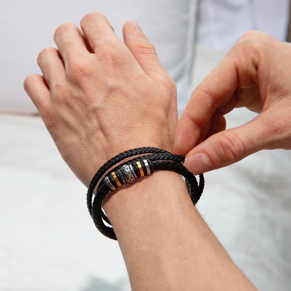 Person wearing 'Love You Forever' nephew bracelet with braided black leather band and engraved message, perfect gift from aunt or uncle.
