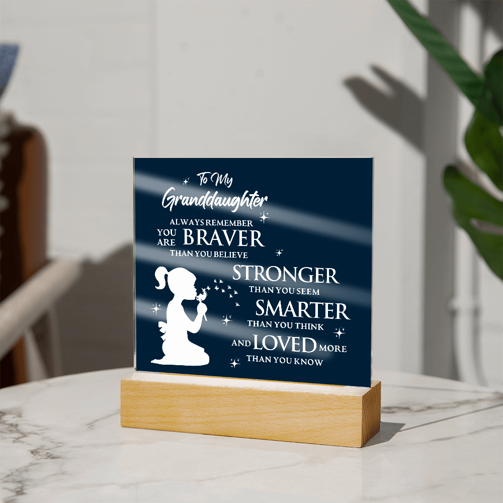 Acrylic plaque with inspirational message to granddaughter, featuring silhouette design, set on a lighted wooden base.