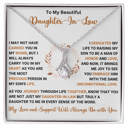Alluring Beauty necklace gift for daughter-in-law with sentimental message, featuring a ribbon-shaped pendant and sparkling details.