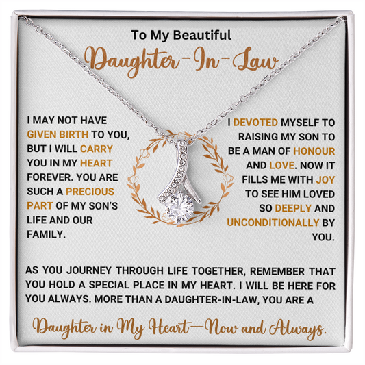Alluring Beauty necklace with heartfelt message for daughter-in-law, featuring a ribbon-shaped pendant and loving words in gift box.