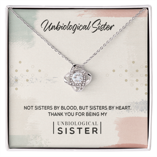 Unbiological Sister Love Knot Necklace with cubic zirconia, heartfelt gift packaging. Perfect for showing unbreakable bonds.