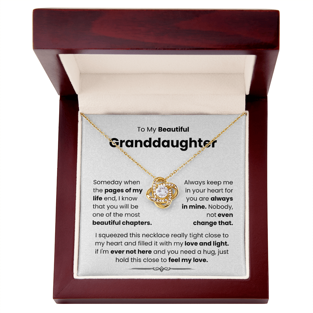 Gold Love Knot Necklace in a box with "To My Beautiful Granddaughter" message, symbolizing unbreakable bond adorned with cubic zirconia.