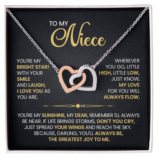 Interlocking hearts necklace for niece with rose gold and silver pendant, featuring heartfelt message card. Gift from aunt or uncle.