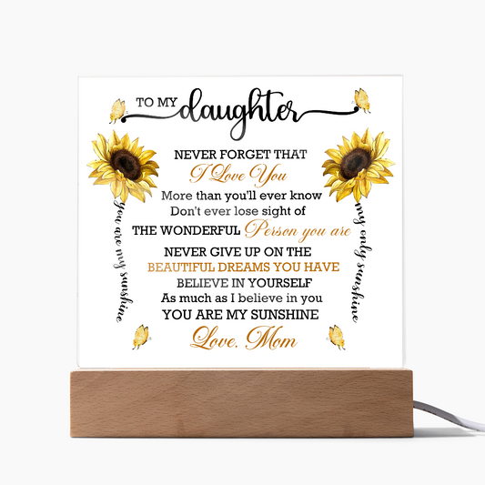 Acrylic plaque with sunflowers and an inspirational message from mom to daughter about love and dreams, featuring a wooden base.