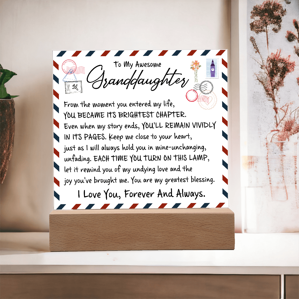 Acrylic plaque gift with love letter design from grandparent, featuring heartfelt message to granddaughter, on glowing wooden base.